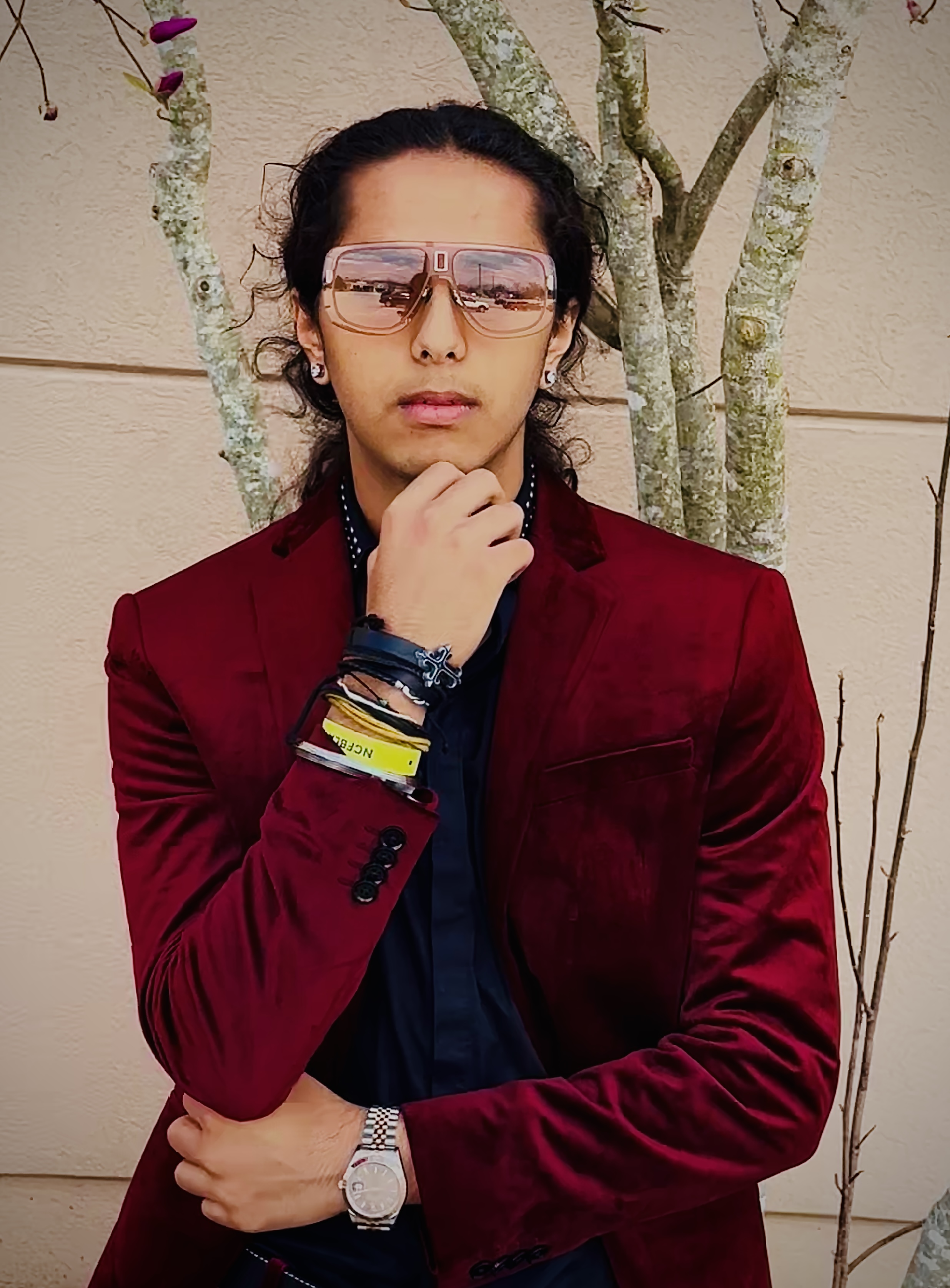 Aryan Rohira dressed in a bold red velvet suit